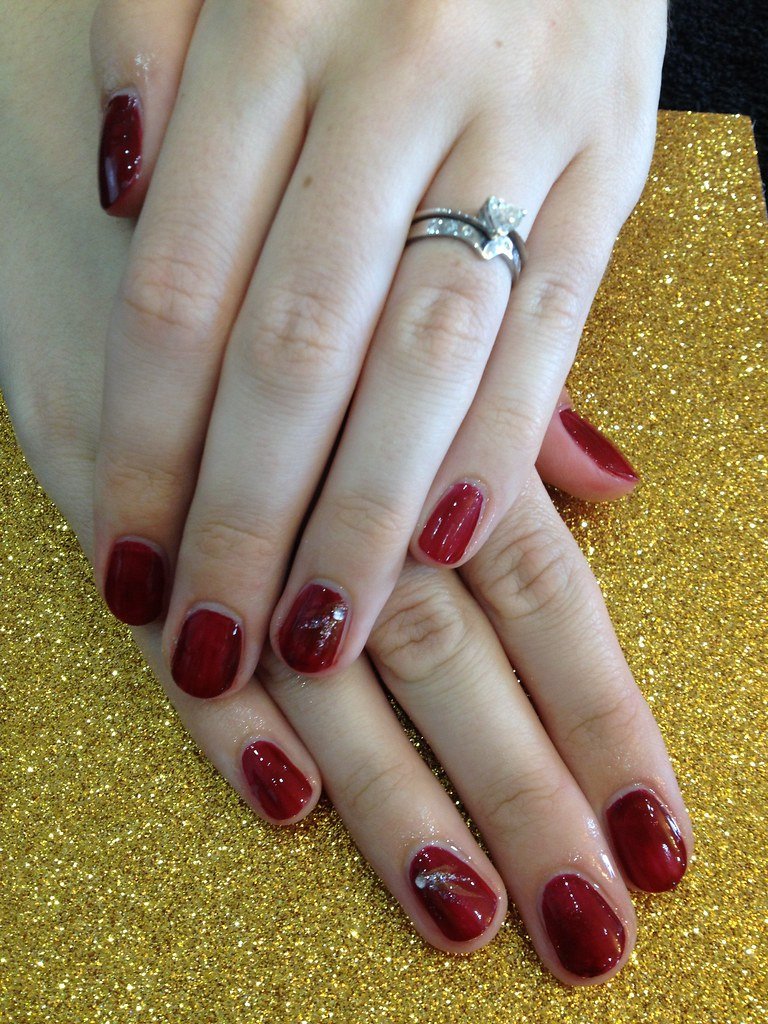 Burgundy polish with free hand nail art