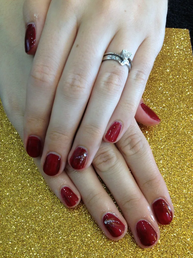 Burgundy polish with free hand nail art