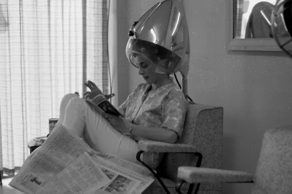 Woman under hair dryer at a beauty shop in Tallahassee