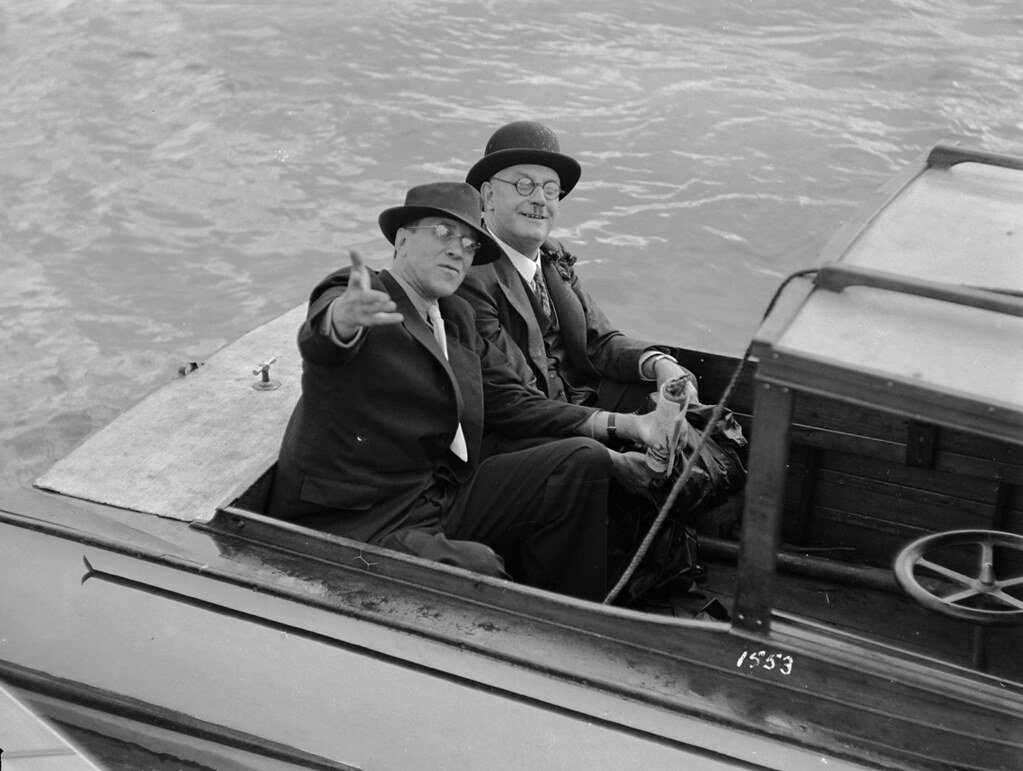 Two men seated in a motor launch on Sydney Harbour, c 1931