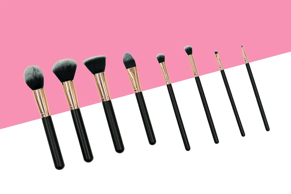 Makeup Brushes on Pink & White Background