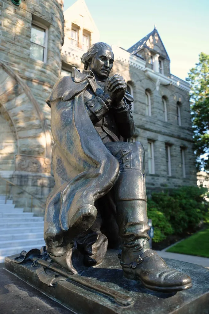 General George Washington lays down his sword and prays, hands in prayer mudra, uniform, cloak, boots, statue, old state capitol building, Olympia, Washington, USA