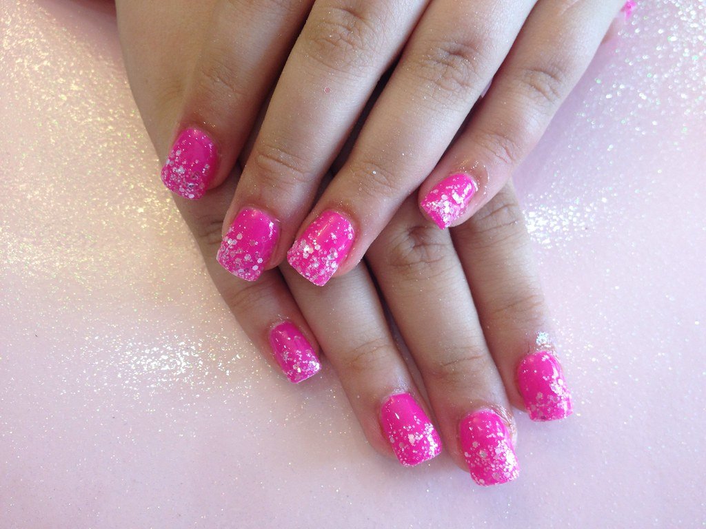 Acrylic nails with pink gel and glitter dust