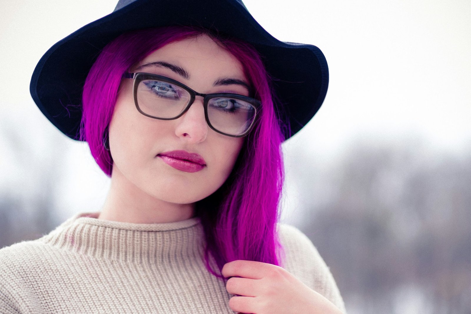 woman in black framed eyeglasses and brown knit sweater