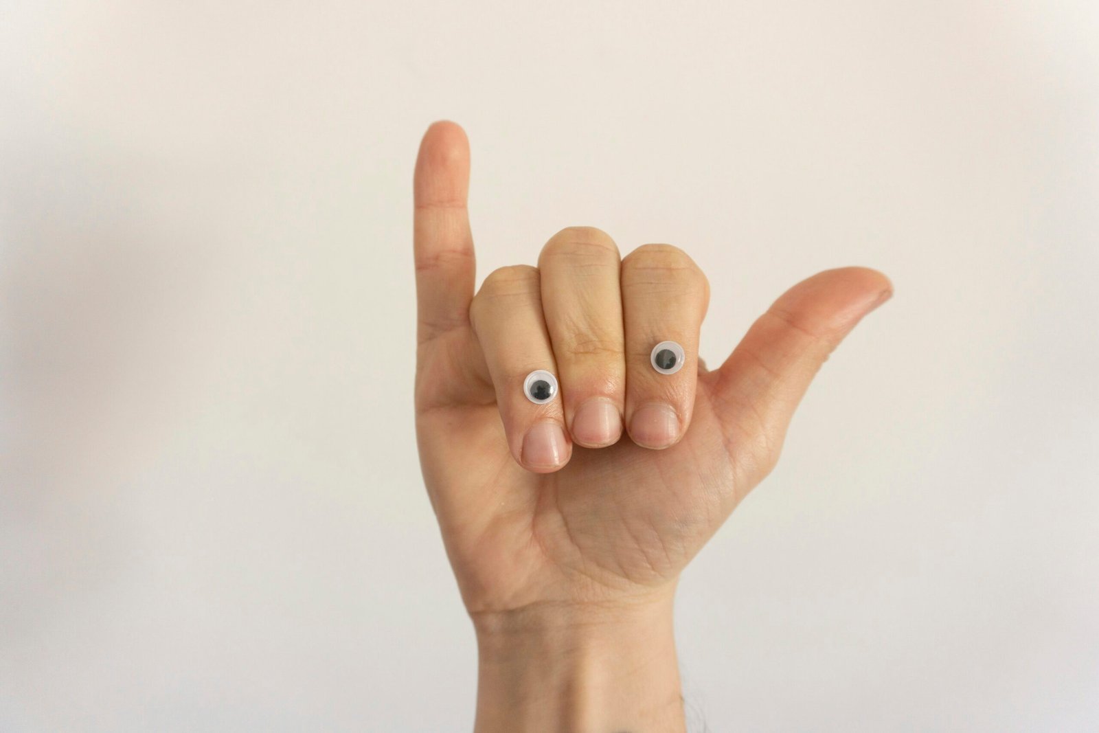 person with white manicure on right hand