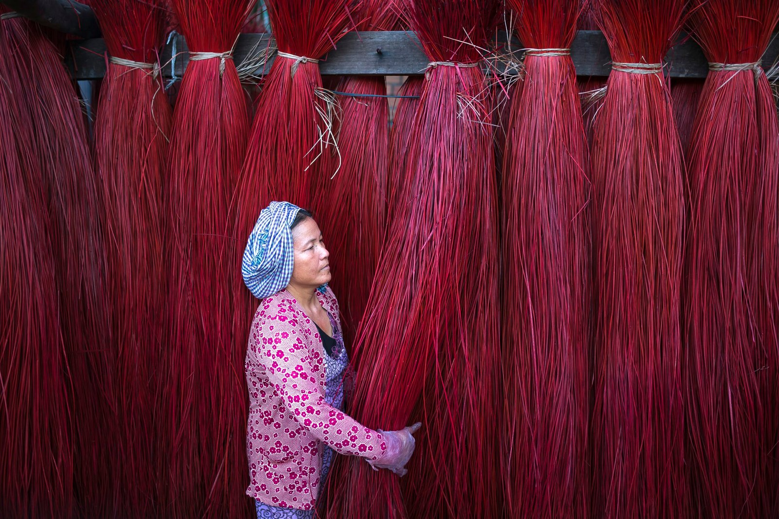 a woman standing in front of a wall of red hair