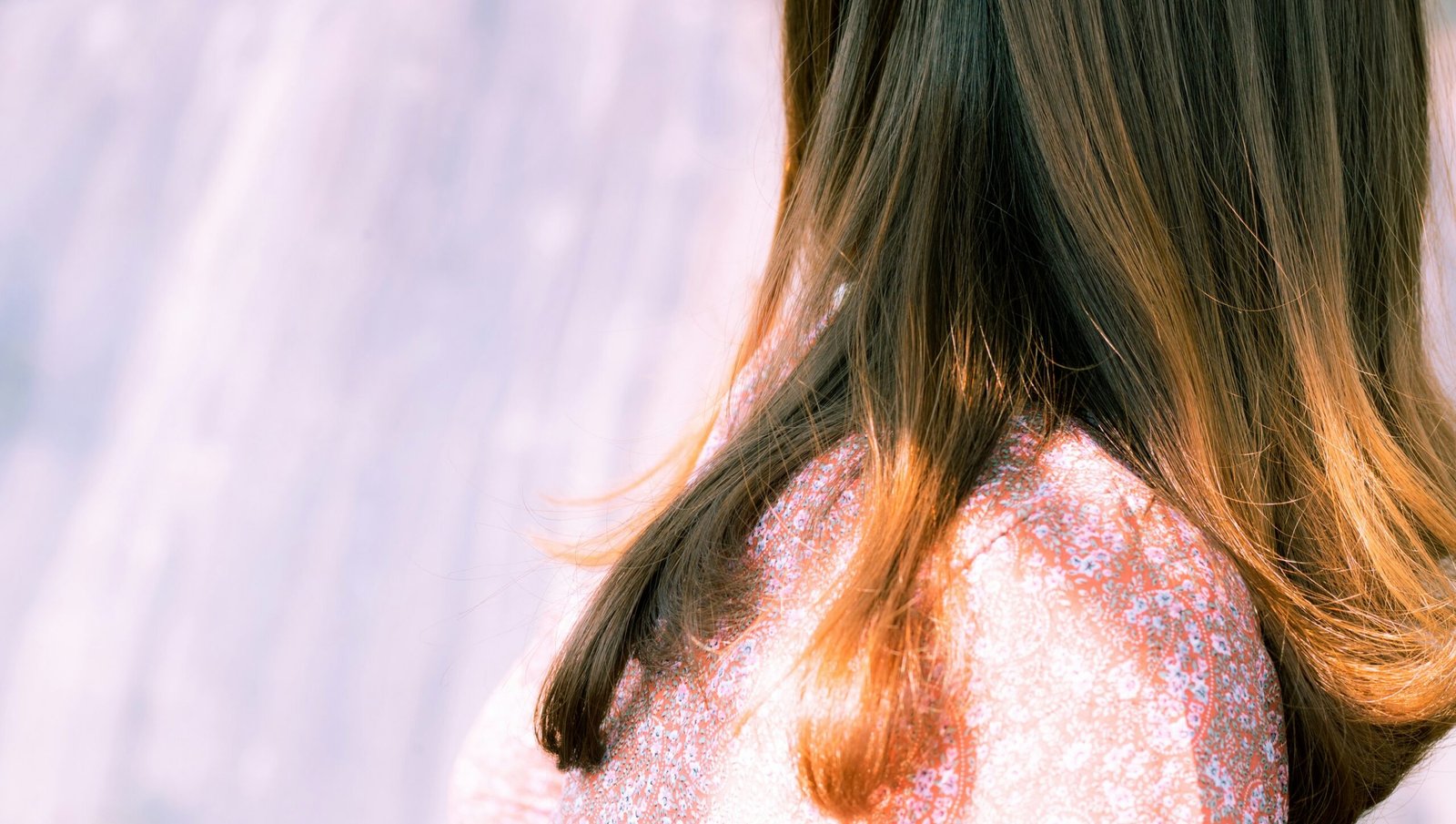 woman with brown hair in white shirt