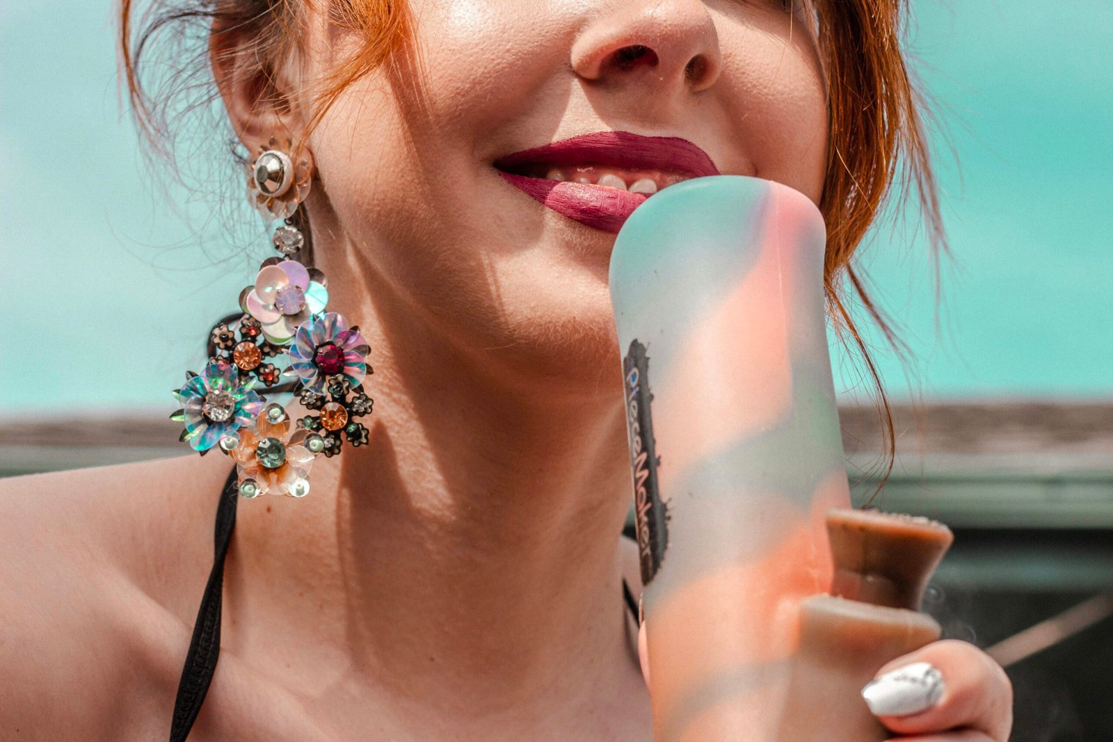 woman with blue and white flower on her mouth