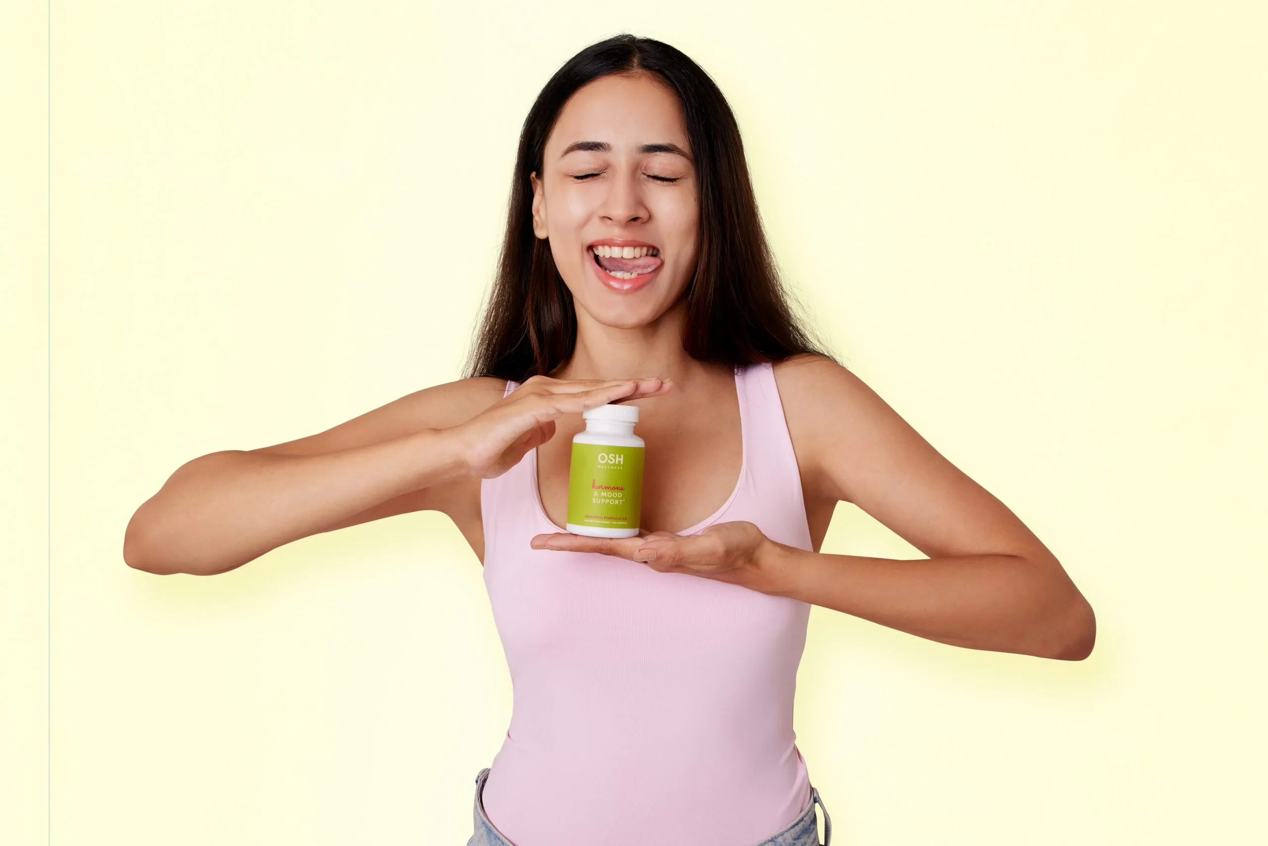 A woman holding a jar of green stuff
