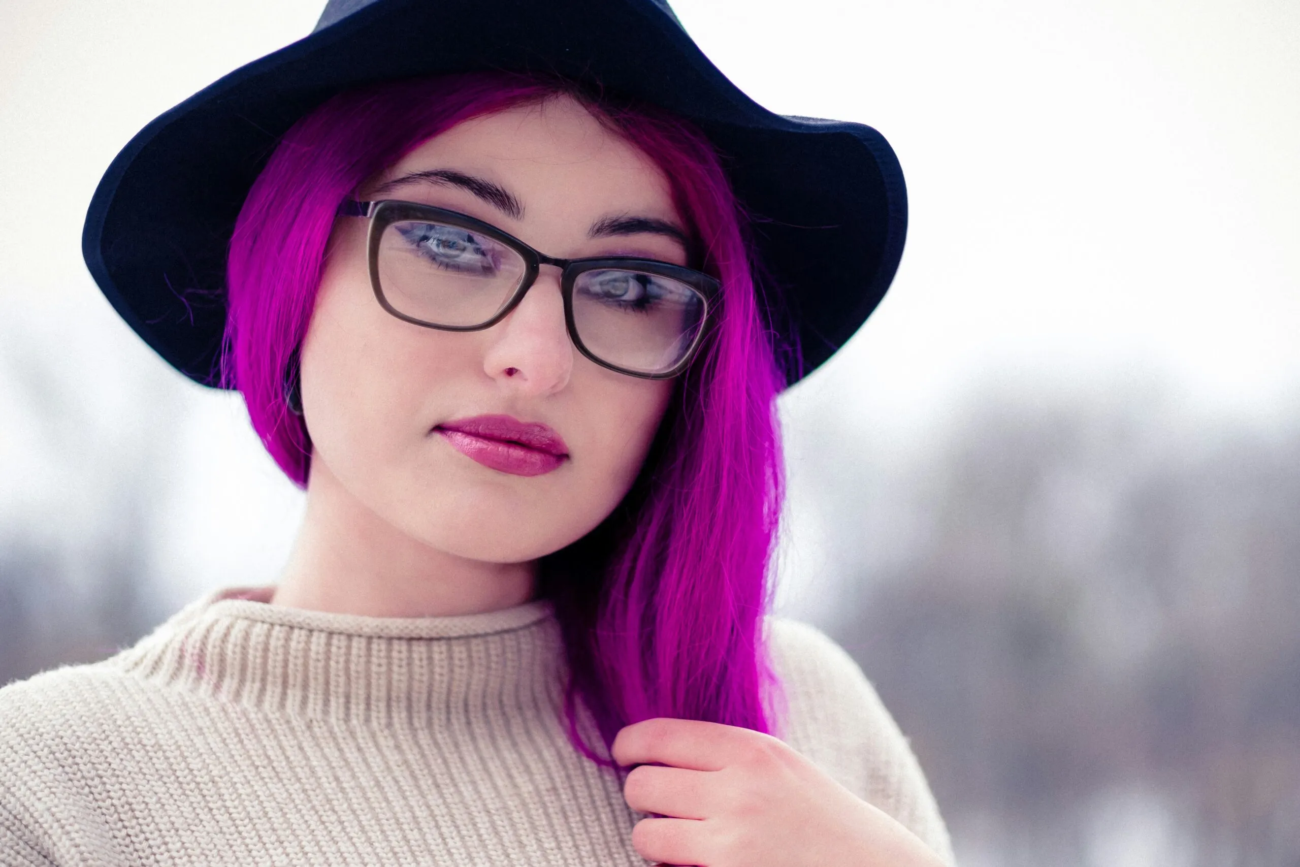 woman in black framed eyeglasses and brown knit sweater