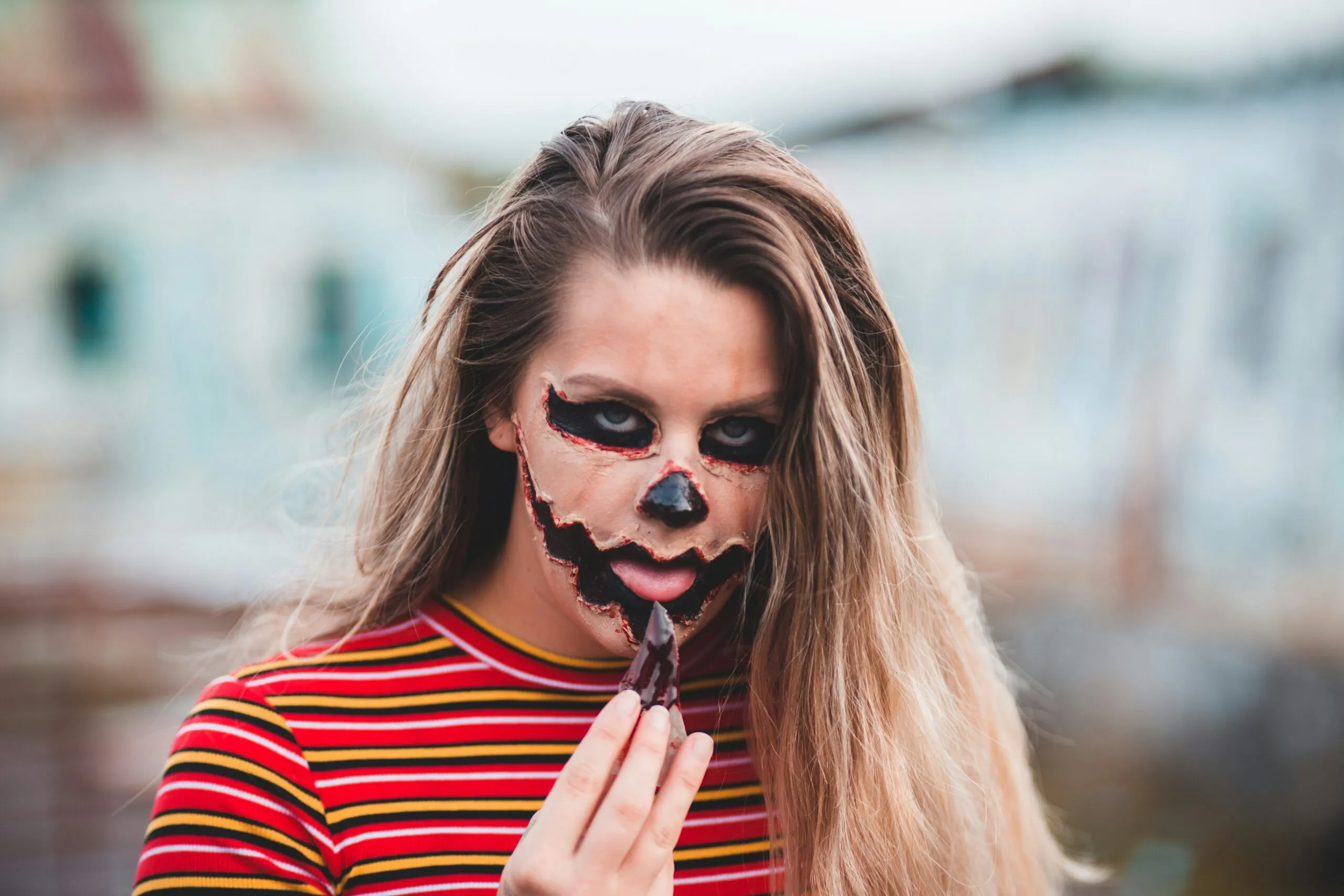 woman in red and black striped shirt with black sunglasses