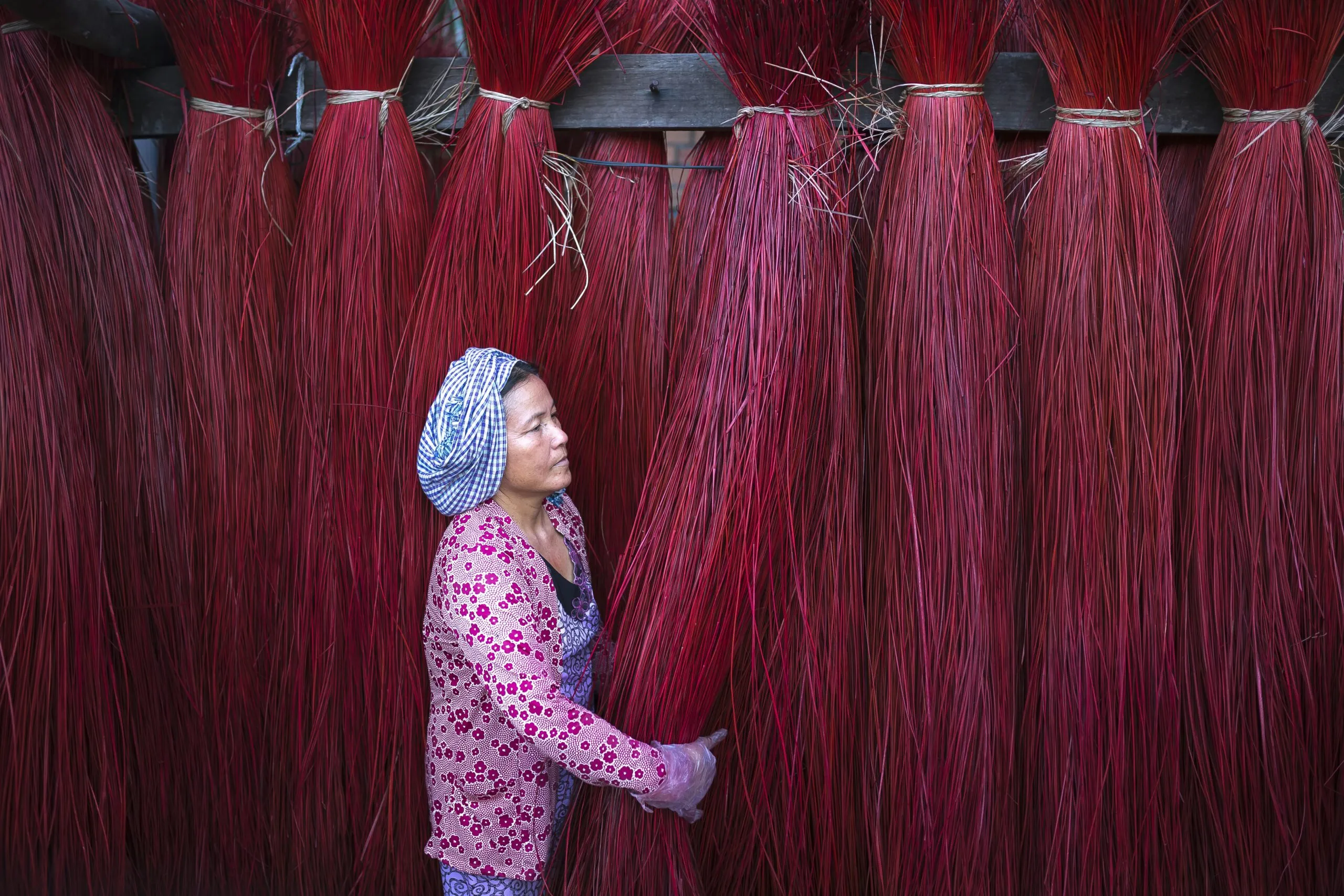 a woman standing in front of a wall of red hair