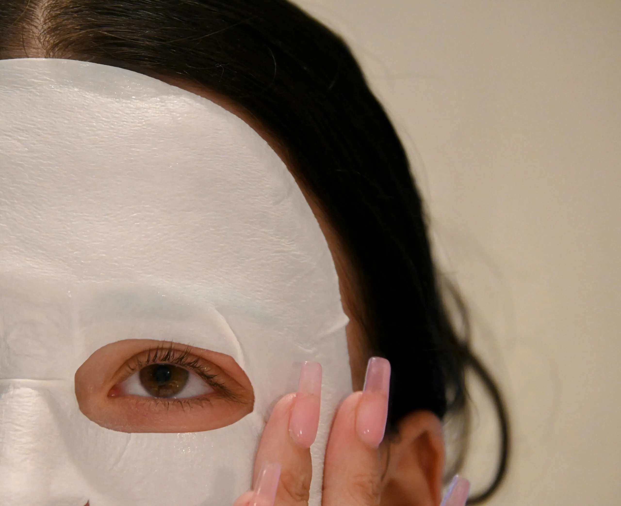 a woman with a white mask covering her face