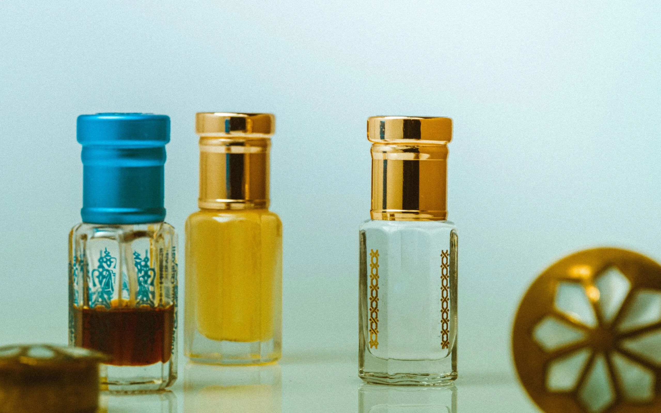 three glass bottles on white table