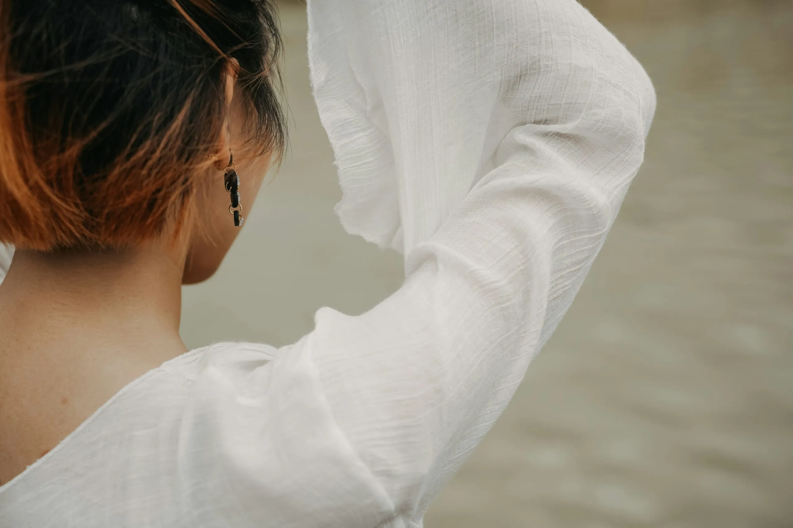 a woman with red hair wearing a white shirt