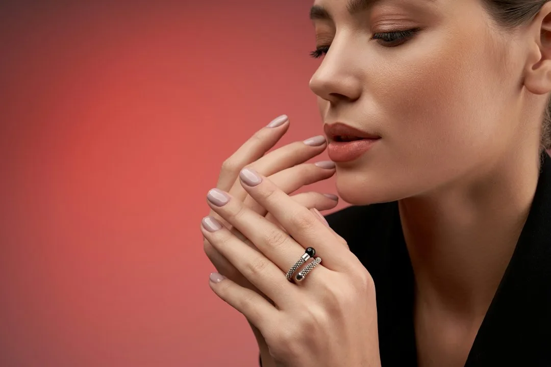A woman in a black dress holding her hands together