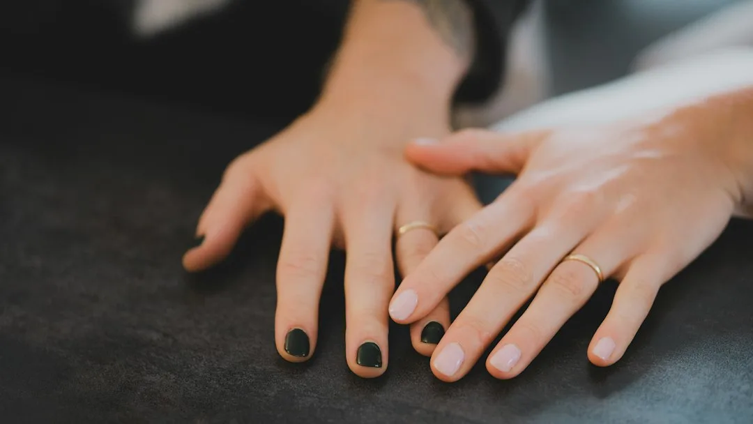 a close-up of hands on a black surface