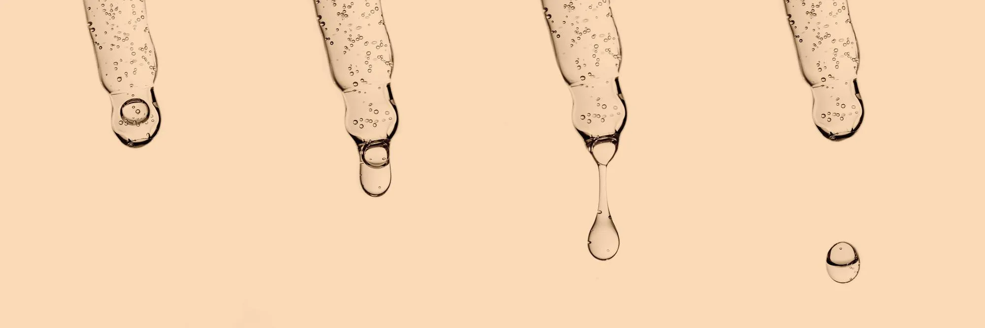 A banner with several pipettes with serum or other cosmetic product