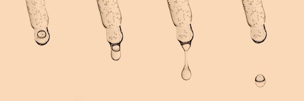 A banner with several pipettes with serum or other cosmetic product