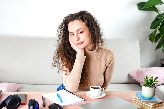 A Charming Young Woman Found in a Cozy Home Office Setting that is Inviting and Modern