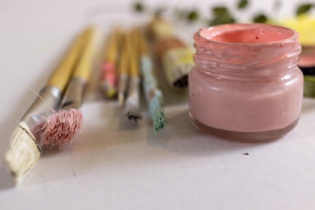 Close-up of paintbrushes in jar on table