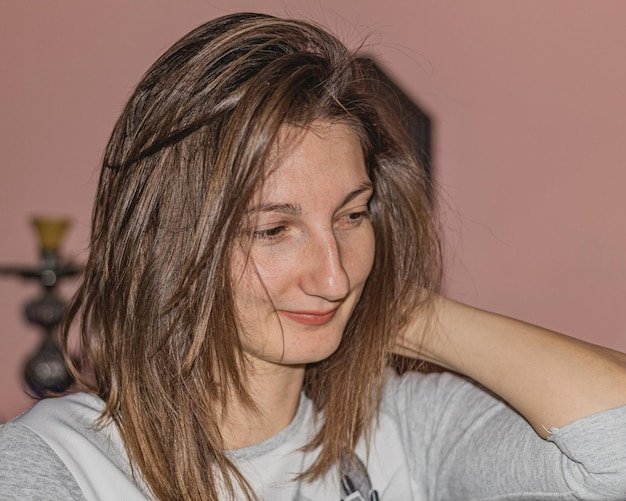Close-up of smiling young woman at home