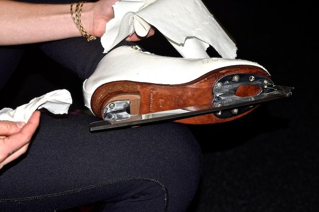 Cropped image of woman cleaning skate