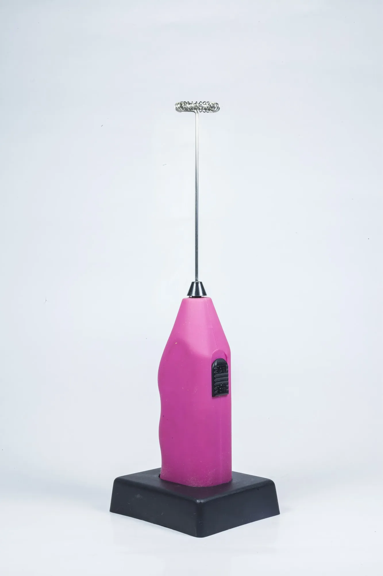 Electric hand drink mixer on white background