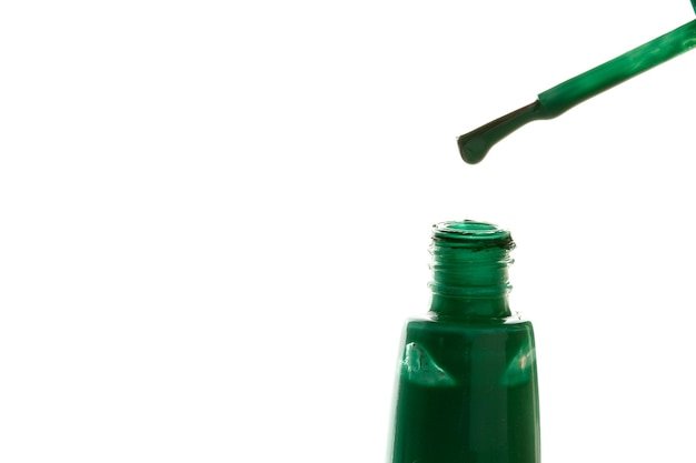 Green polish nail on white background