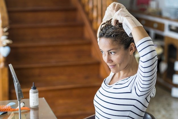 Home made hair dye at home for beauty young caucasian woman looking at the mirror