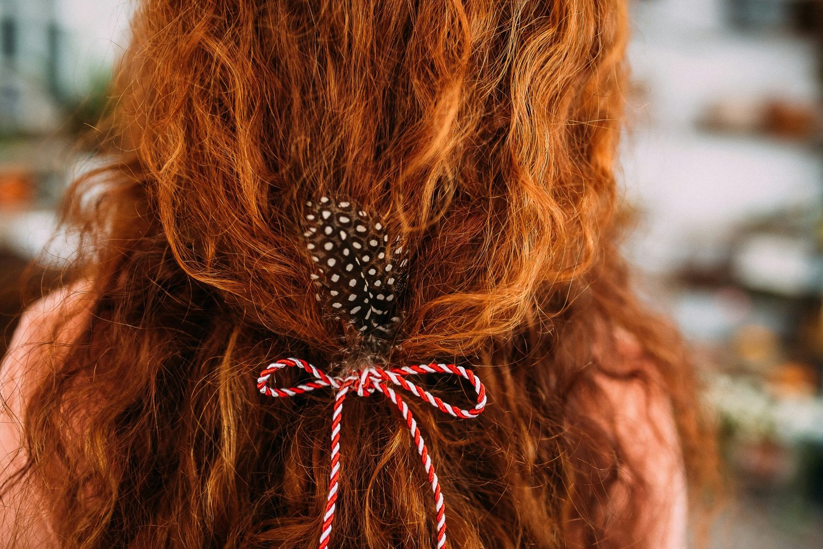 person with red and white bow hair tie on hair