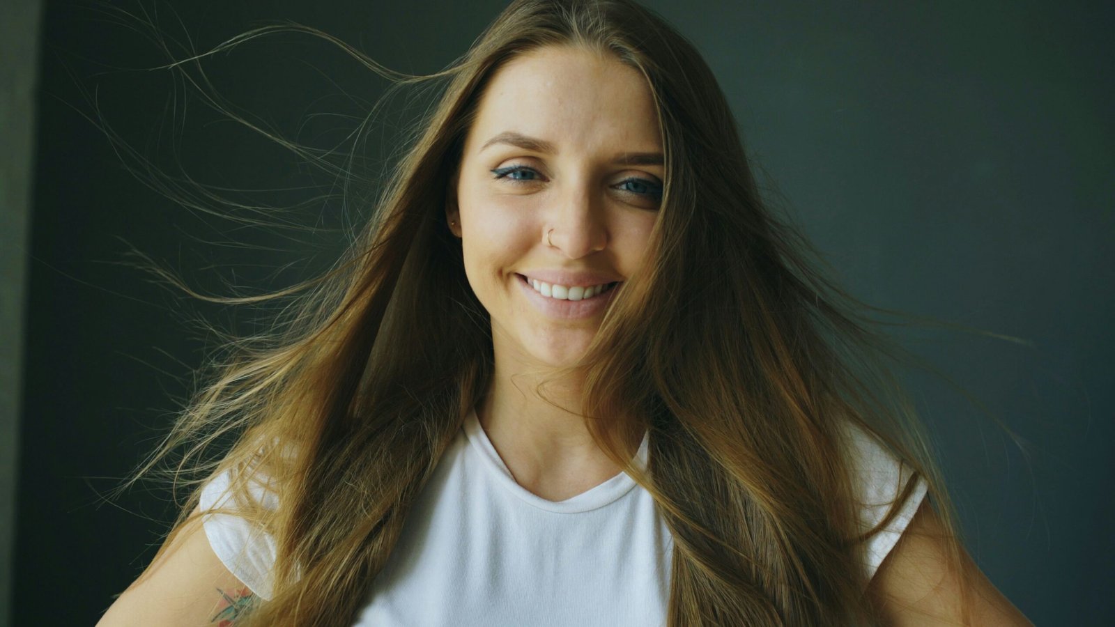 Young woman with long brown hair smiling