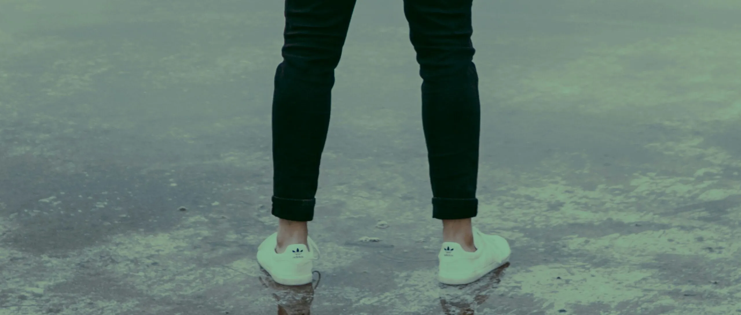 man wearing white sneakers and black pants