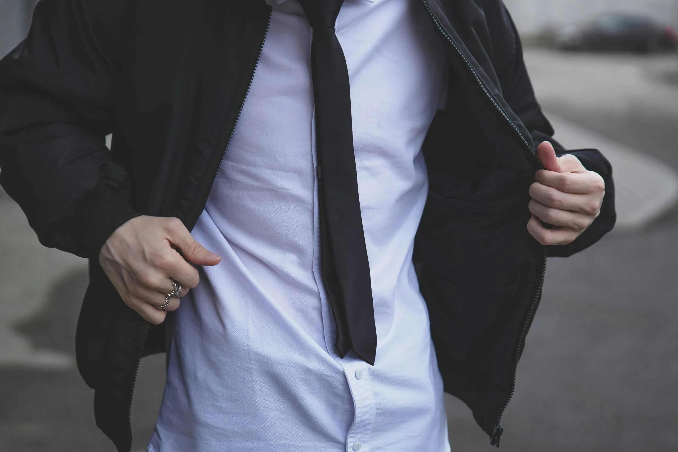 A man is wearing a suit jacket and tie.