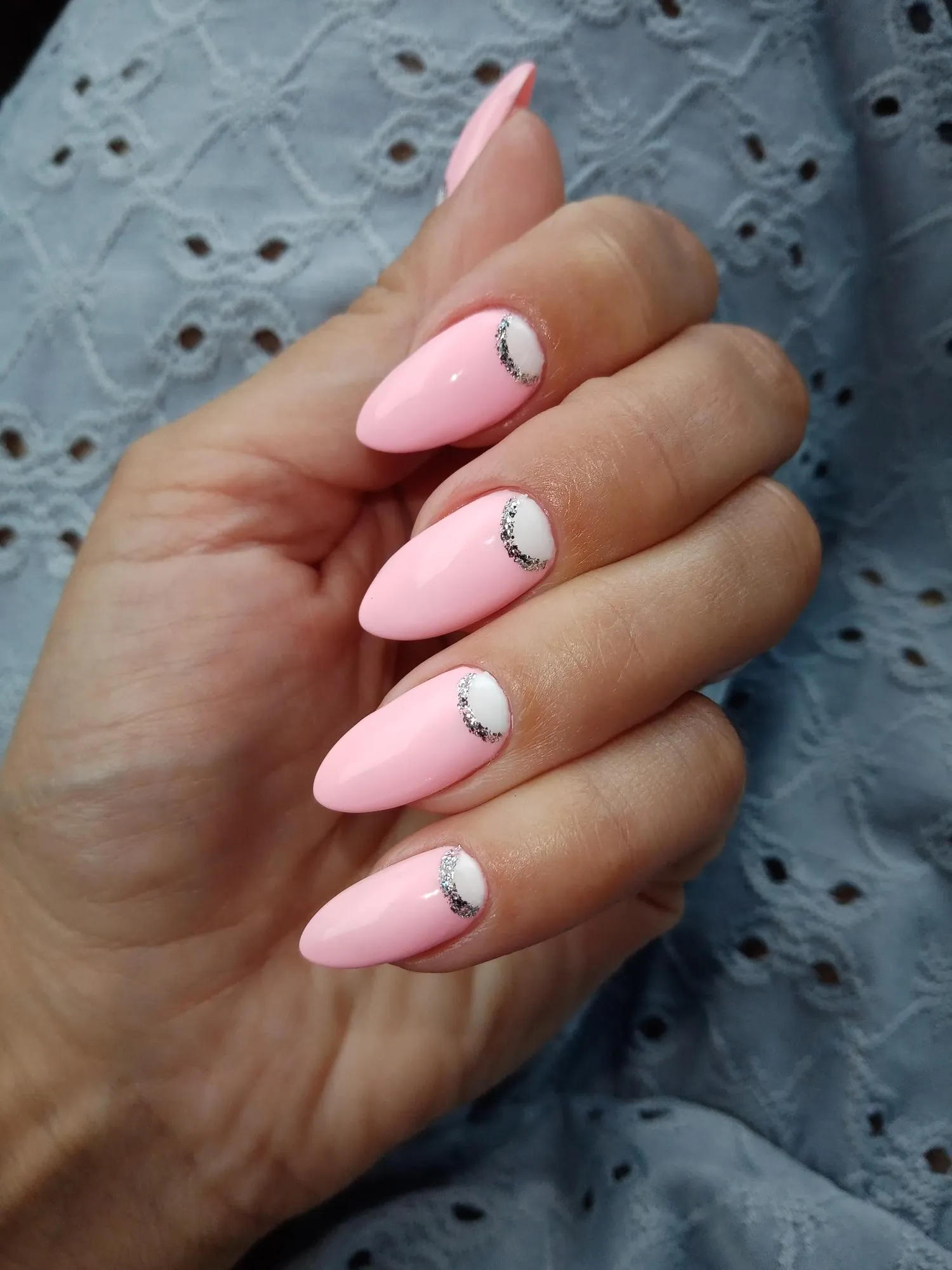 Pink nail design on a womans hand