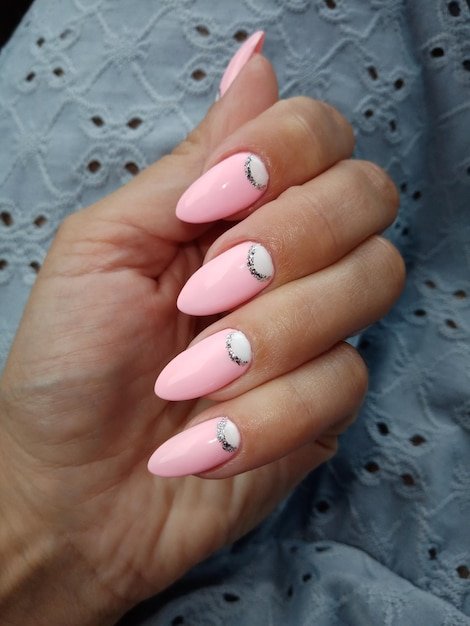 Pink nail design on a womans hand