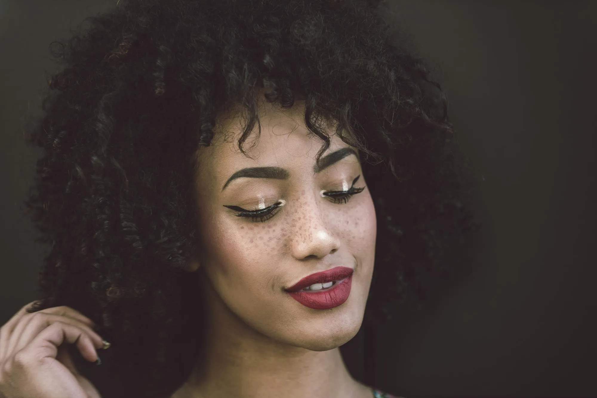 Portrait of woman against black background