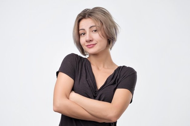 Smiling woman in black shirt with crossed arms looking and smiling