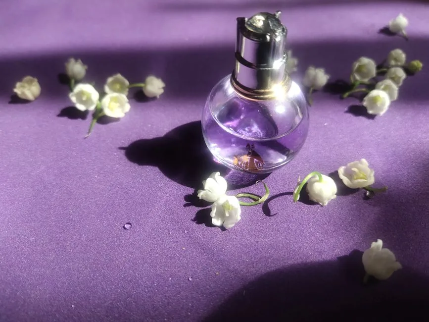 A perfume bottle surrounded by lily of the valley flowers on a purple background, capturing a sense of elegance.