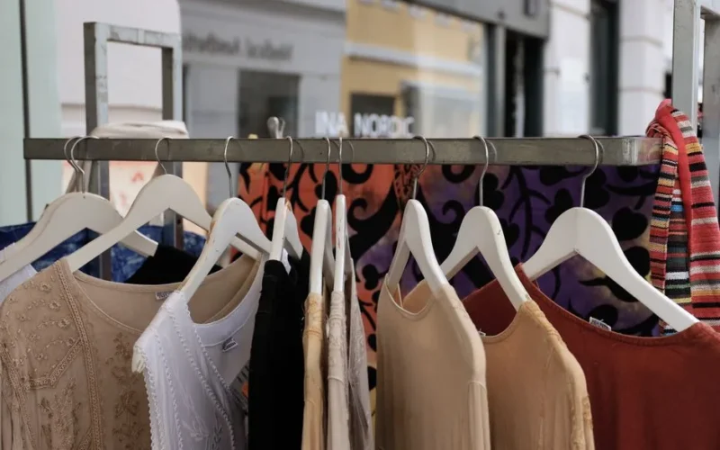Vibrant clothing on hangers at a boutique in Copenhagen, capturing diverse textures and patterns.