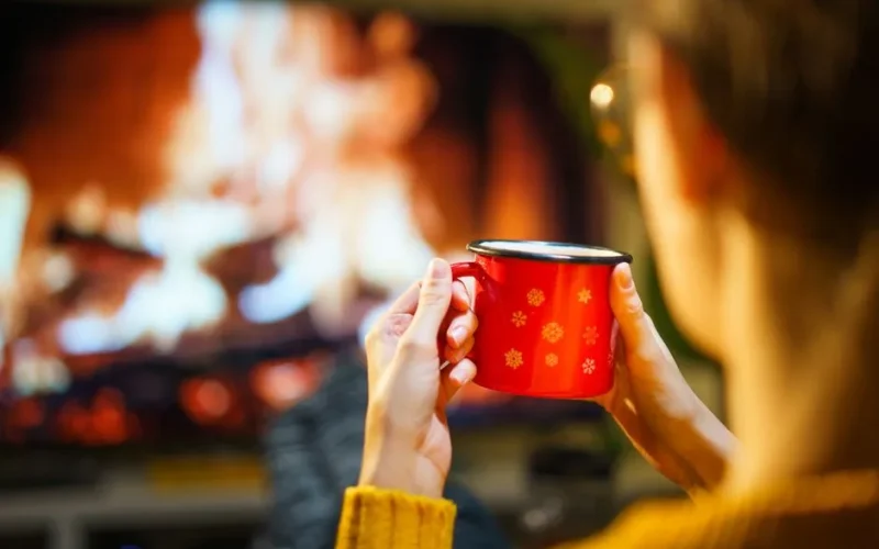 A relaxing winter evening with a warm drink by the fireplace. Perfect for cozy indoor moments.