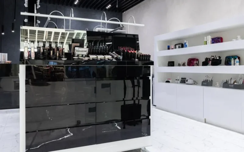 Wide-angle view of a sleek, contemporary cosmetics display in a stylish store interior.
