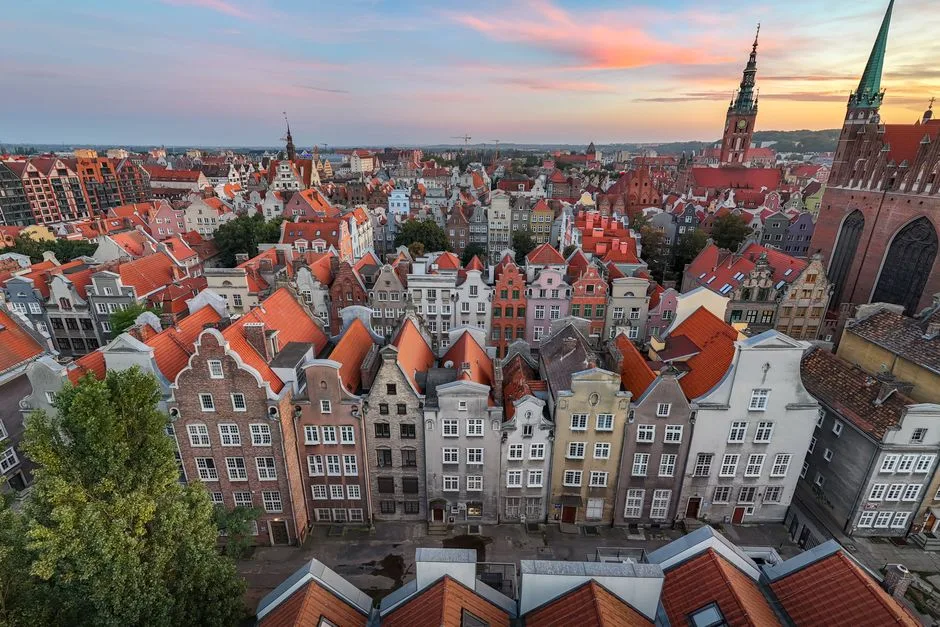 Aerial view of the historic Old Town of Gdańsk with colorful townhouses and St. Mary's Church.