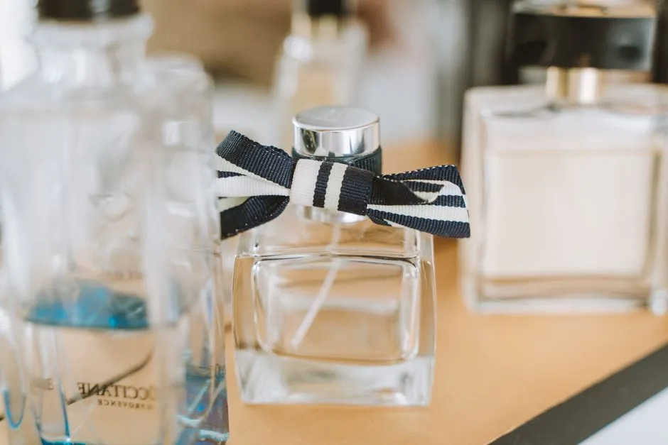 Close-up of elegant perfume bottles with focus on one with ribbon.